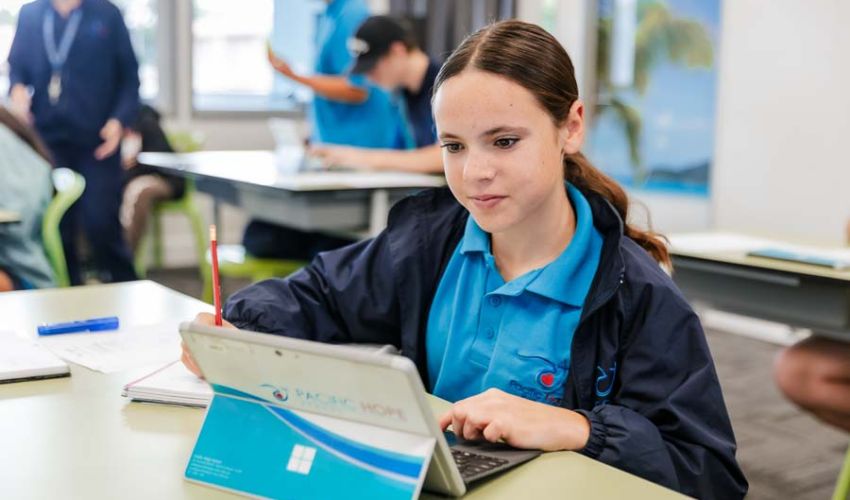 A student using a computer to complete classwork.