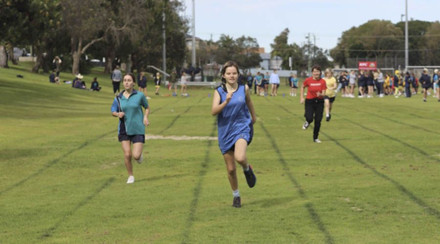 Students participating in the school athletics carnival, showcasing their dedication and sportsmanship in various track and field events.