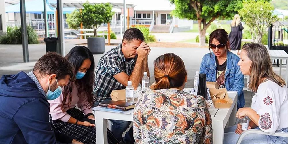 Parent community gathering in prayer